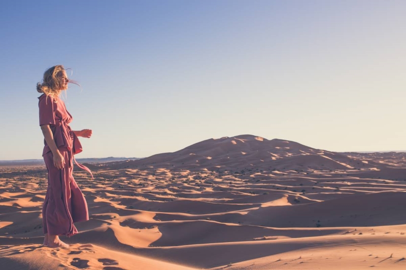 Girl in the desert A girl in the desert looking at the sun, in her thoughts.